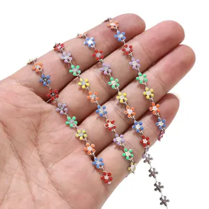 Close-up view of colorful enamel flower chain details, stainless steel handmade DIY jewelry accessory.