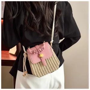 Detailed view of the stylish straw woven box bag with unique rope straps and chic design.