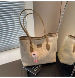 Stylish women straw tote bag large capacity woven handbag with cute plush charm for commute.