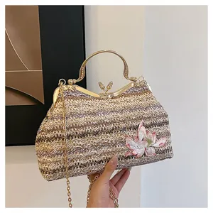 Detailed view of casual woven straw handbag featuring elegant metal handle and lotus embroidery.