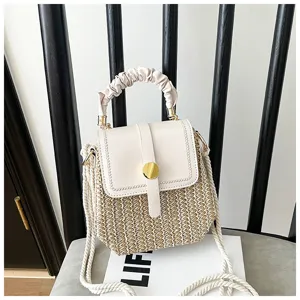 Stylish straw woven crossbody bag with white leather flap and chic gathered handle.