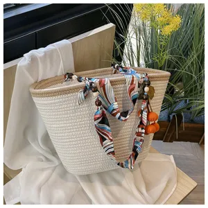 Woven rope tote shoulder bag for women, large capacity beach straw bag with silk scarf charm.