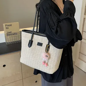 Stylish straw woven tote bag for women, large capacity commuter shoulder bag with contrast trim.