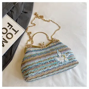 Colorful woven straw shoulder bag detail with elegant gold clasp and embroidered floral motif.