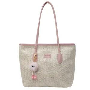 Large capacity straw tote bag for women, stylish pink PU leather handles and cute keychain decor.