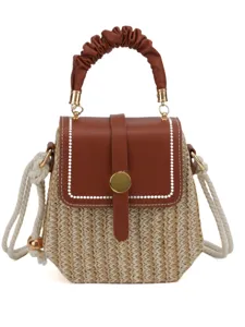 Woven straw crossbody bag for women with brown PU leather flap and gathered handle.