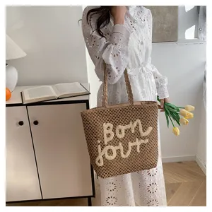 Woven straw tote bag for women, casual summer beach shoulder bag with chic letter embroidery.
