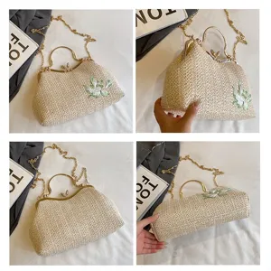Straw woven crossbody bag with metal frame kiss lock and floral embroidery for women stylish.