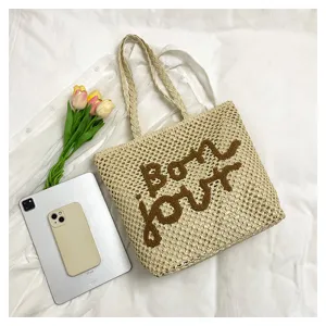 Stylish women straw woven tote bag with brown letter embroidery, perfect for summer beach vacation.