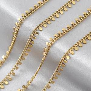 Macro detail of gold stainless steel dot chain, perfect for DIY jewelry making and necklaces.