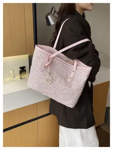 Pink tweed shoulder tote bag with elegant chain and metal M charm, stylish women underarm bag detail.