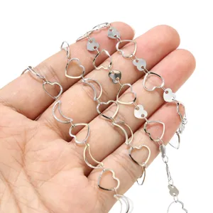 Stainless steel heart and moon chain link detail close up, DIY jewelry accessory part.