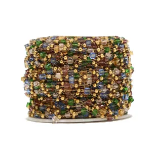 Detailed view of colorful glass crystal beaded chain on spool for DIY jewelry making.