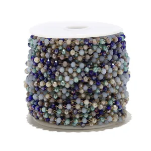 Detailed view of colorful crystal beaded chain on spool for DIY handmade necklace jewelry making.