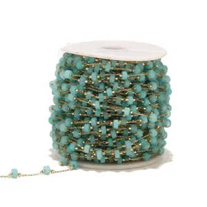 Close-up detail of turquoise beaded chain on spool, perfect for DIY jewelry making and crafts.