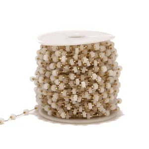 Stainless steel gold bead chain roll with white beads for DIY jewelry making and accessories.