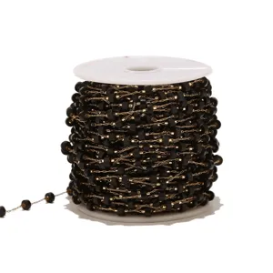 Detailed close-up of black beaded chain on spool, gold tone stainless steel DIY jewelry part.
