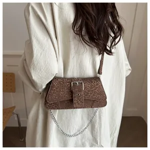 Detailed shot of retro leopard print shoulder bag with silver buckle and chain design.