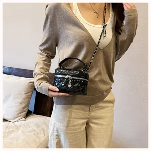Mini black quilted chain crossbody bag for women, stylish vintage vanity handbag.