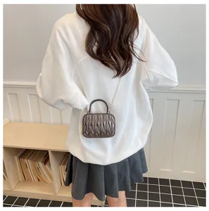Mini pleated shoulder bag with top handle and chain strap, elegant retro crossbody design.