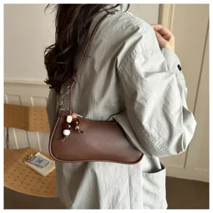 Detailed view of stylish brown PU leather shoulder underarm bag featuring lovely bead charm.