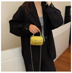 Detailed view of the luxury metallic gold pleated mini crossbody bag with chic chain strap.