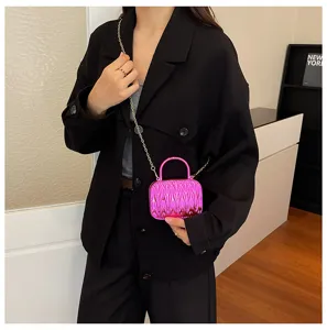 Detailed view of fashionable mini metallic pleated shoulder bag with chain strap and handle.