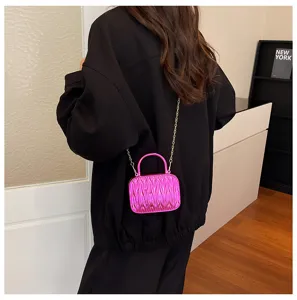 Mini pleated crossbody handbag with chain strap, bright pink stylish shoulder bag for women detail view.