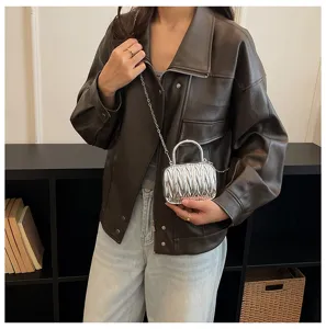 Detailed showcase of the metallic silver pleated mini handbag featuring a stylish chain strap.