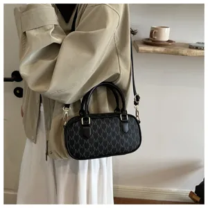 Modische minimalistische schwarze zylindrische Handtasche mit Monogramm-Muster für den Alltag.