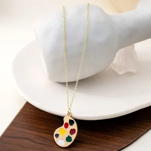 Exquisite gold-plated necklace featuring a colorful art paint palette pendant, vintage style.