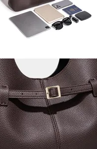 Detailopname van de bruine lederen hobo-tas met metalen gesp en ruime opbergcapaciteit.