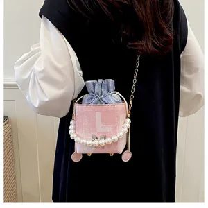Detailed view of the stylish pearl handle bucket bag with blue drawstring lining and chain strap.