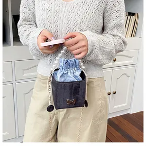 Stylish pearl handle bucket bag with denim drawstring insert and cute butterfly charm detail for women