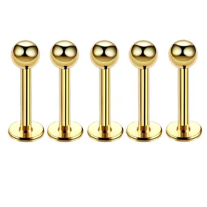 Close up detail view of five gold stainless steel labret stud body piercing jewelry items.