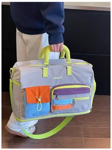 Detail shot of color-blocking dopamine travel duffel bag, large capacity, multi pockets.