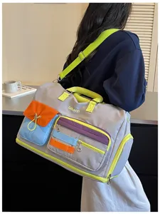 Colorful travel duffel bag detail showing neon straps, multi-pockets, and large capacity.