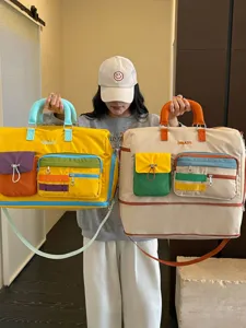 Color-block large capacity travel duffel bag, stylish and versatile commuter luggage bag.