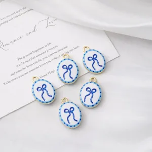 Close-up view of oval blue bow charm pendants, perfect for DIY jewelry accessories.