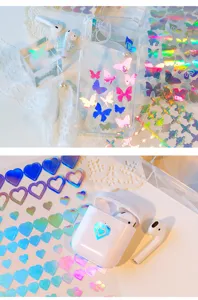 Details of PET laser stickers featuring holographic butterfly and heart designs for journals.