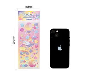 Detailed view of holographic star and moon stickers with size reference phone scale.