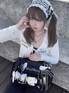 Detailed close-up shot of Japanese style ita bag with clear window and bear charm.