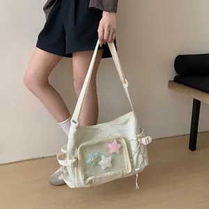 Japanese style canvas ita bag with transparent front pocket and plush star charms.