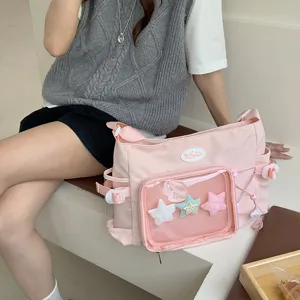 Detailed view of the pink ita bag with transparent window, star charms, and spacious storage.