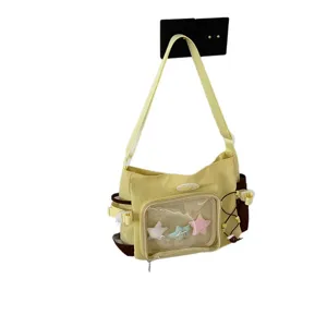 Casual Japanese style yellow canvas shoulder ita bag with transparent window and cute star charms.