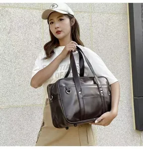 Detail showcase of the classic Japanese style PU leather JK uniform shoulder bag in dark brown.