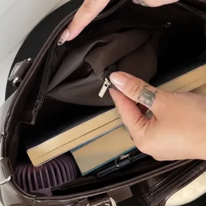 Detailed interior view of the dark brown large capacity ita bag with zipper pocket.