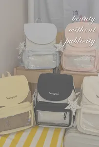Stylish waterproof canvas school backpack with clear front pocket and star pendant for women.
