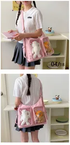 Pink star ita bag with clear front pockets and cute plush toys for daily commute.