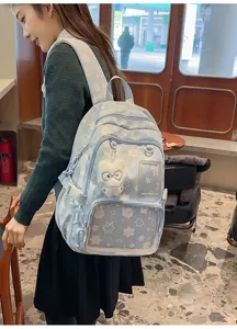 Japanese style cute star printed school backpack with transparent front pocket and plush doll.